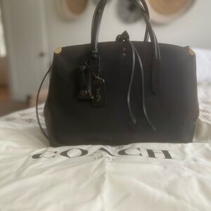 Barely used black leather, simple, and elegant Coach bag.